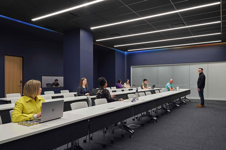 rendering of the cyber range command centre as a classroom with dark walls and lines of desks