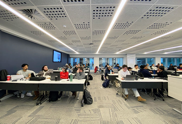 students sitting at desks in a classroom