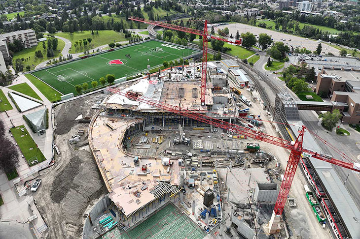 aerial view of the Taylor Family Campus Centre construction site showing two cranes and a concreate superstructure