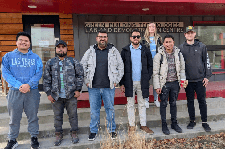 Six students and one SAIT instructor stand outside our Green Building Technologies building.