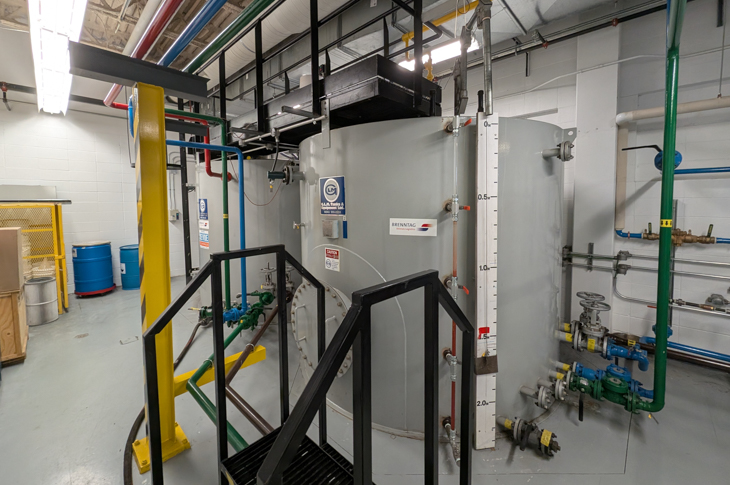 Two 100-barrel storage units complete the wellsite production simulation.