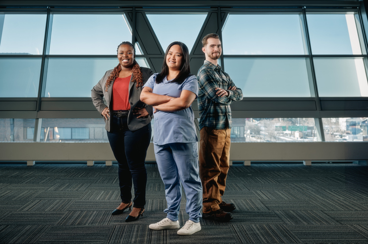 SAIT students post in front of window.