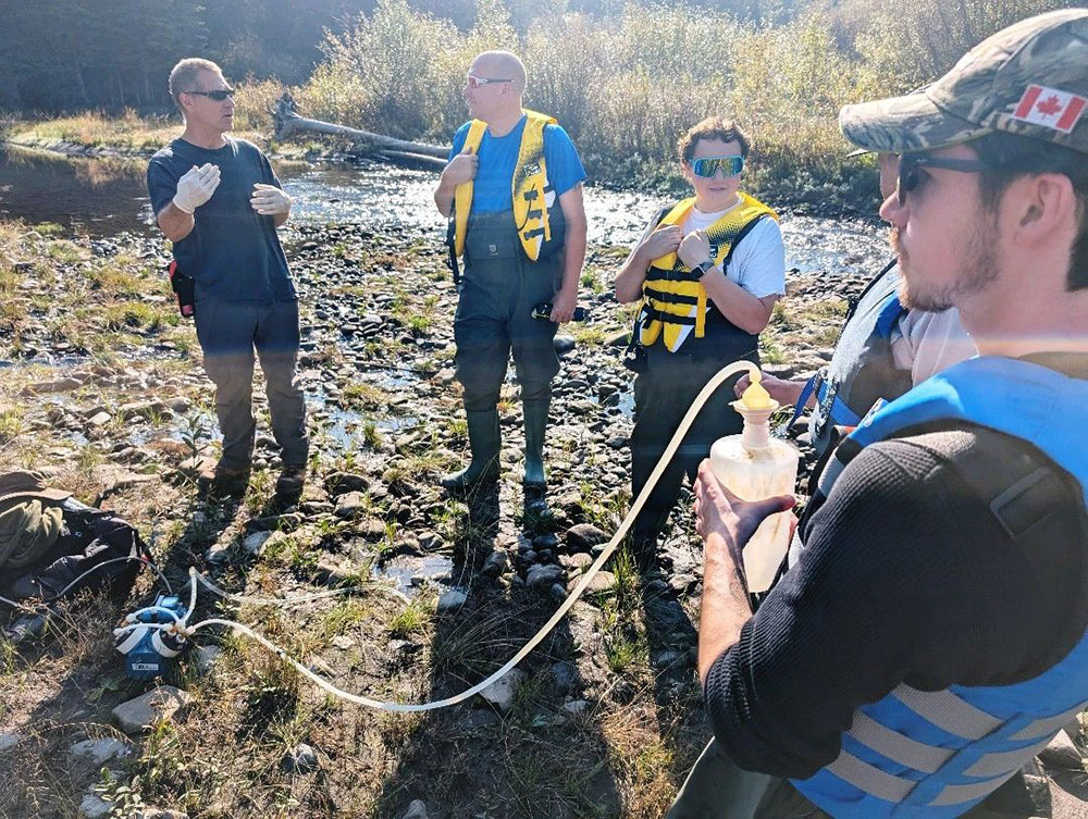 A group of people standing in a river
