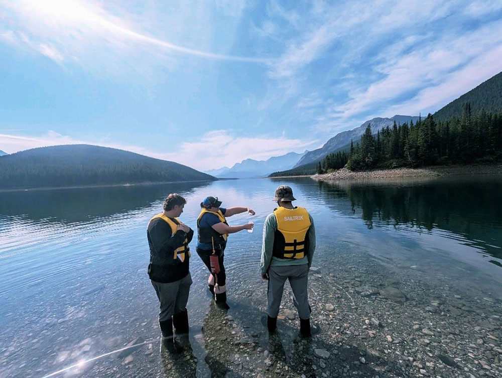 A group of people standing on a rocky shore