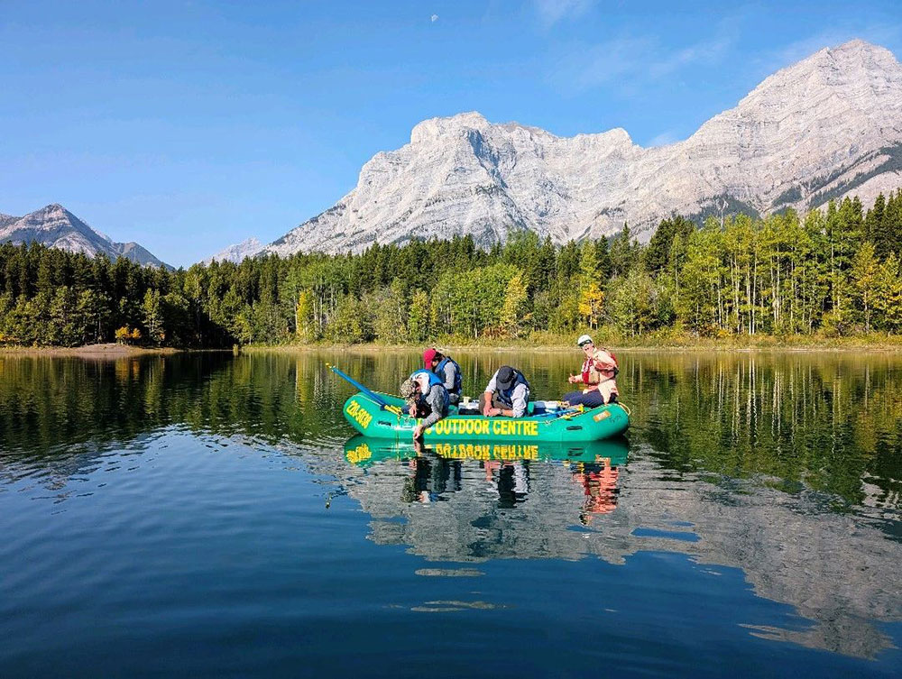 A group of people in a boat on a lake
