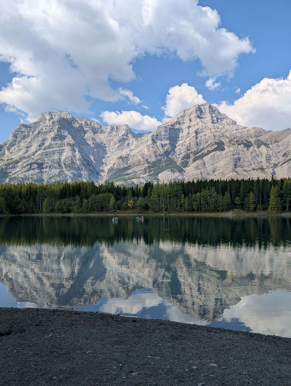 A lake with mountains in the background