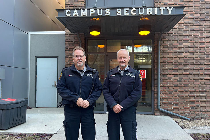 SAIT's Community Peace Officers standing in front of a building with a sign for Campus Security