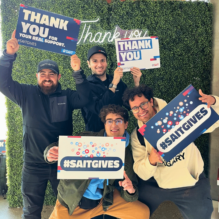 group of young men holding thank you signs
