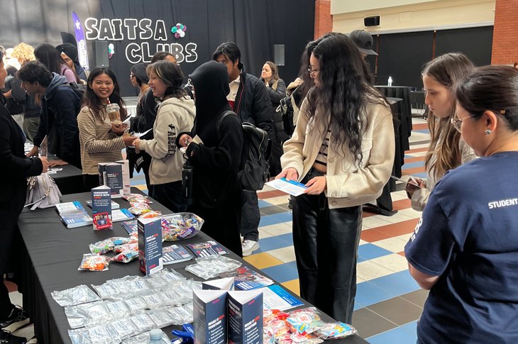 Students visit booth.