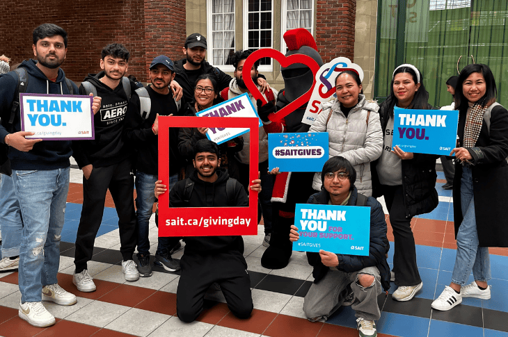 Group of students holding up signs of gratitude