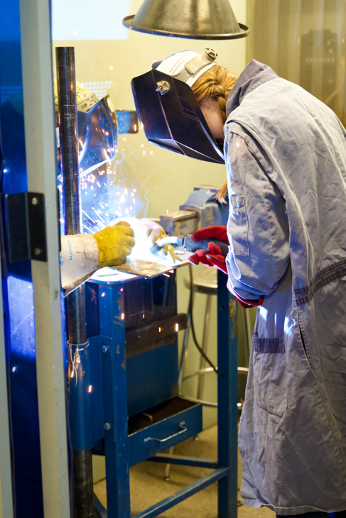 Junior high student learns to use welding tools