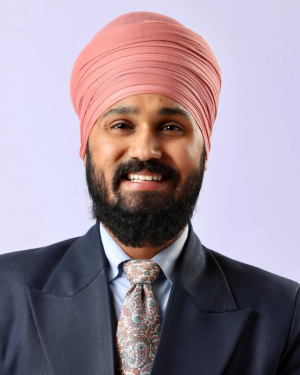 A professional headshot of Kulbir Singh in front of a grey background.