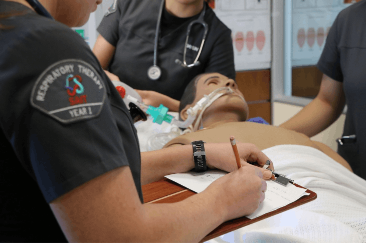 First-year Respiratory Therapy students diagnose and treat a manikin in a high-fidelity simulation. 
