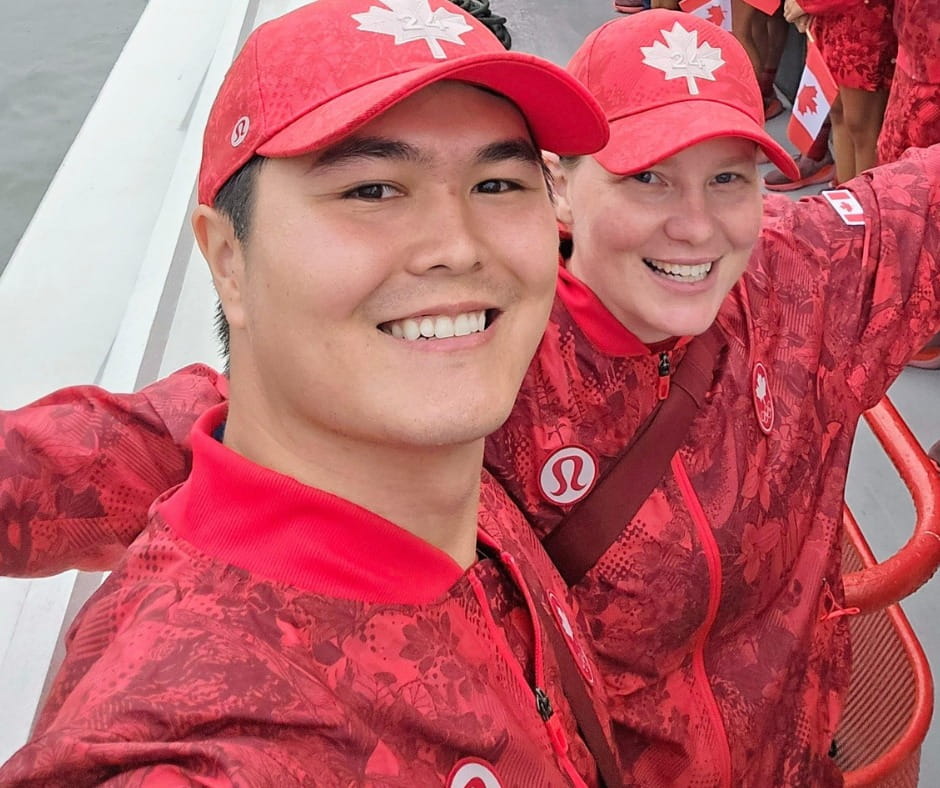 Tye Ikeda and Team Canada teammate Shannon Westlake wear red Team Canada swag and smile at the camera.