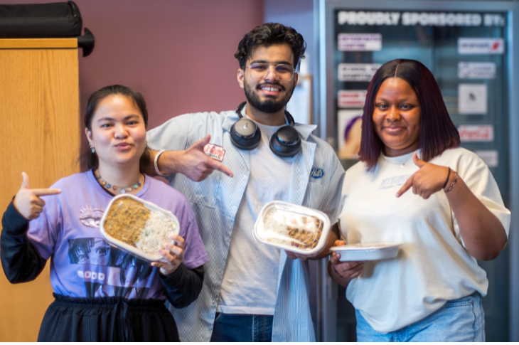 students pointing at food