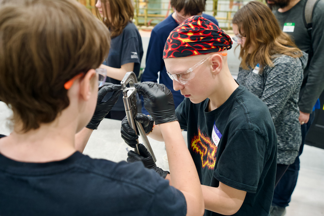 Students work on riveting sheet metal.