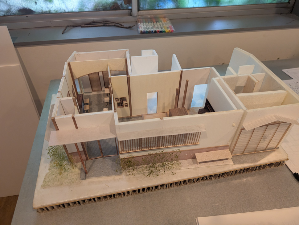 Detailed architectural model of a building displayed on a table.
