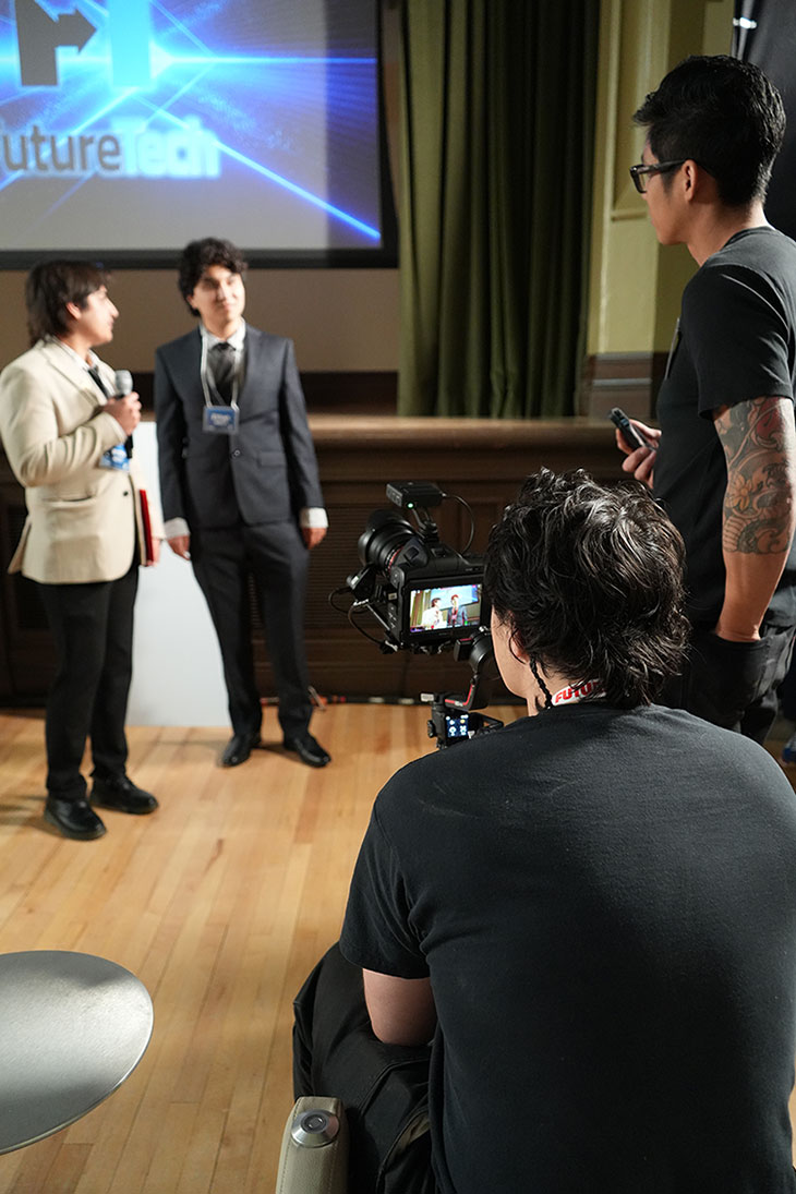 students with camera equipment interview the student winners of FutureTech