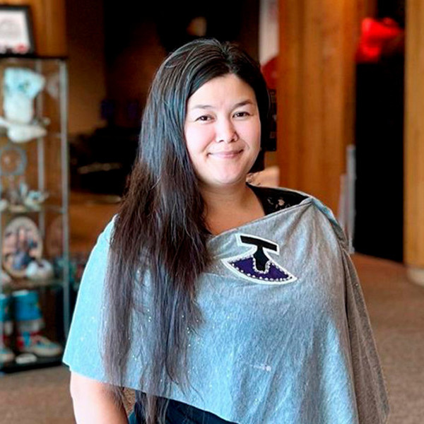 Tapaarjuk Moore smiling while standing in Chinook Lodge