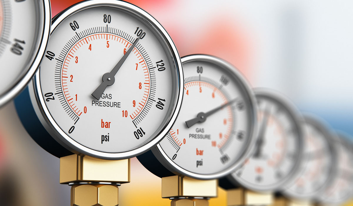 Close-up of multiple gas pressure gauges displaying measurements in bar and psi.