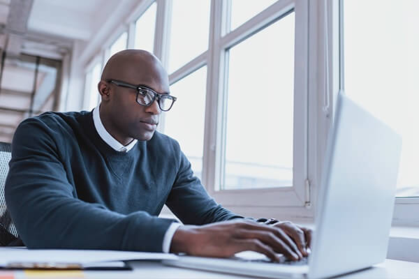 a guy typing on a computer