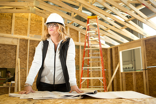 Women at construction site wearing a safety helmet