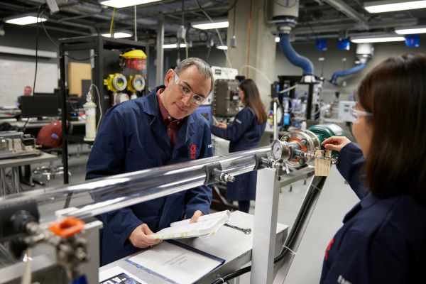 People working in a lab in safety wear