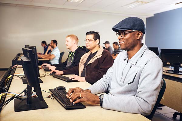 A group of people sitting in a class room
