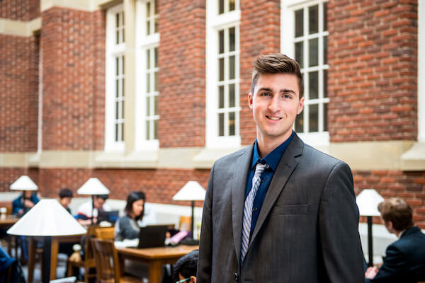 Man dressed in suit smiles at camera