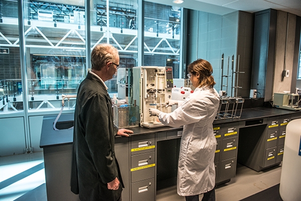 A student and instructor working in a lab testing samples