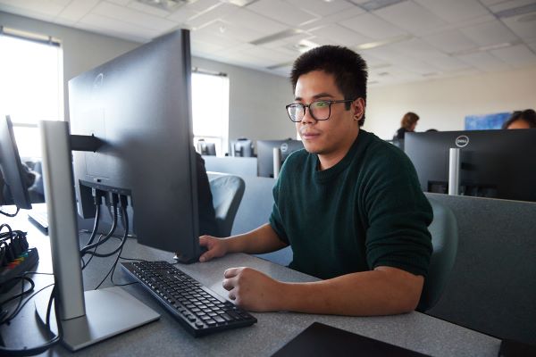 A student using a computer in a classroom