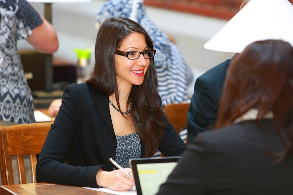 A petroleum land administration student networking on campus