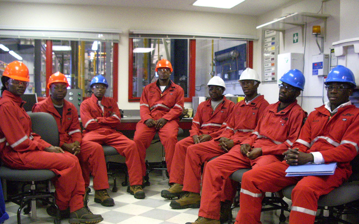 A group of employees with Angola LNG pose for a photograph in the SAIT Rance Fisher Wellsite Production Education Centre