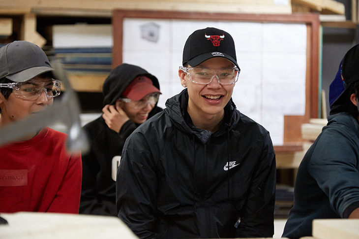 Aiden Potts, camp chaperone, enjoys a laugh with fellow campers during a challenge to see who could best hammer a nail. After five years at the camp – four of them as a camper – Potts says it has inspired him to pursue a career in the trades. 