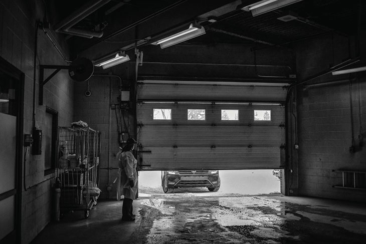A black and white photo of inside a drive-thru COVID testing centre.