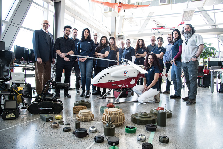 SAIT students and faculty pose with an unmanned aerial vehicle.