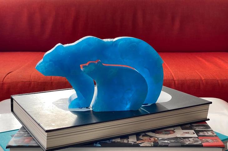 Two blue bears sitting on a book