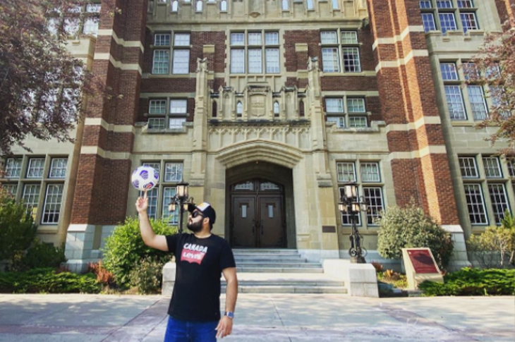 man holding soccer ball in front of sait