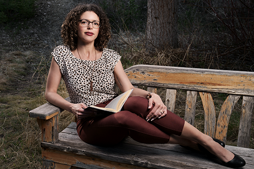 Woman sitting on bench with book