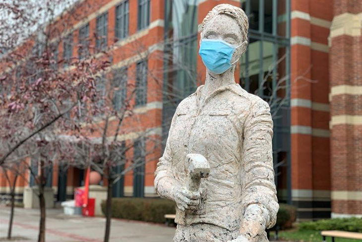 statue on sait campus wearing mask