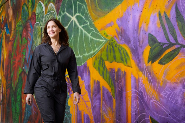 Shelley Kulpers walking in front of a mural