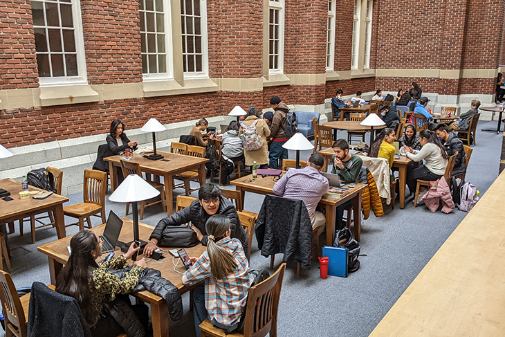 Students sitting at tables in a study hall