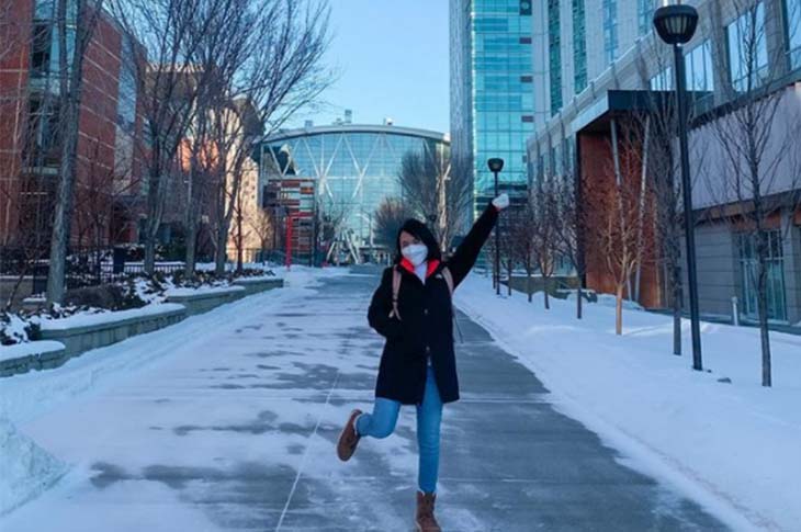 girl smiling on sait campus in winter