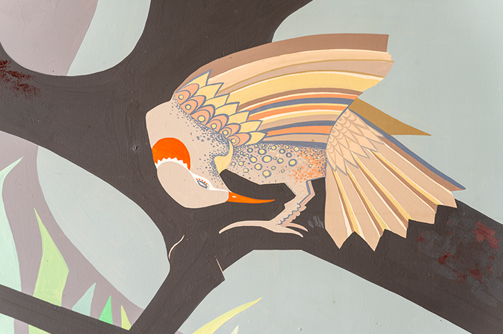 close up of a grey and white bird on mural