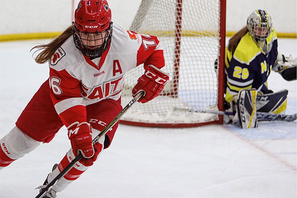 Brittany MacDonald in playing hockey at a SAIT Trojan.