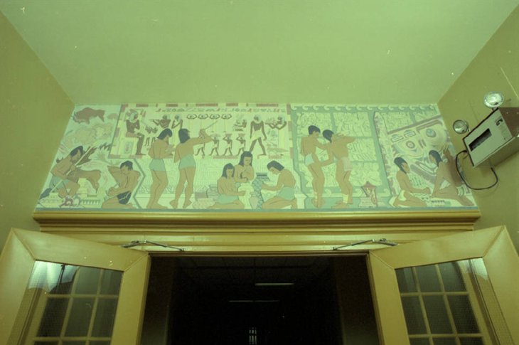 Mural titled "Evolution of record keeping" can be seen above the doors of the entrance to the third floor from the eastern stairwell in Heritage Hall.