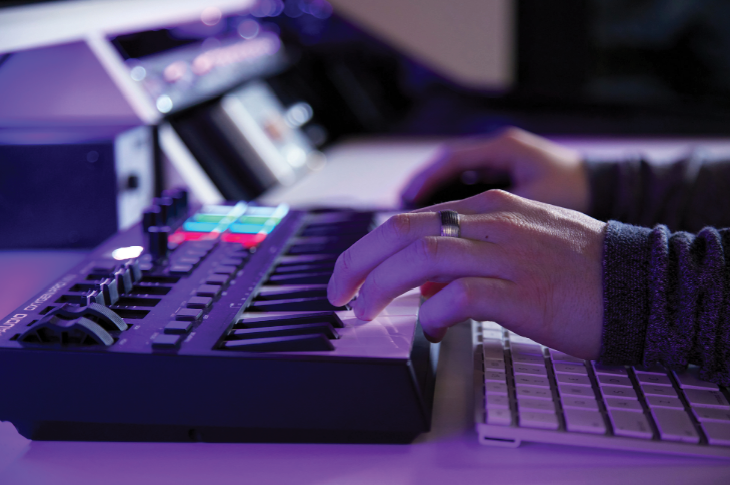 Photo of a man's hands on a sound mixing machine