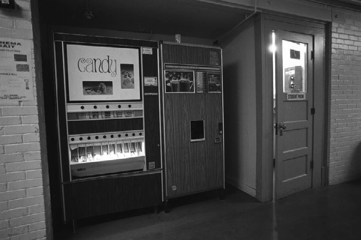 A vending machine and coffee machine inside Heritage Hall. Also seen is a phone room for students.