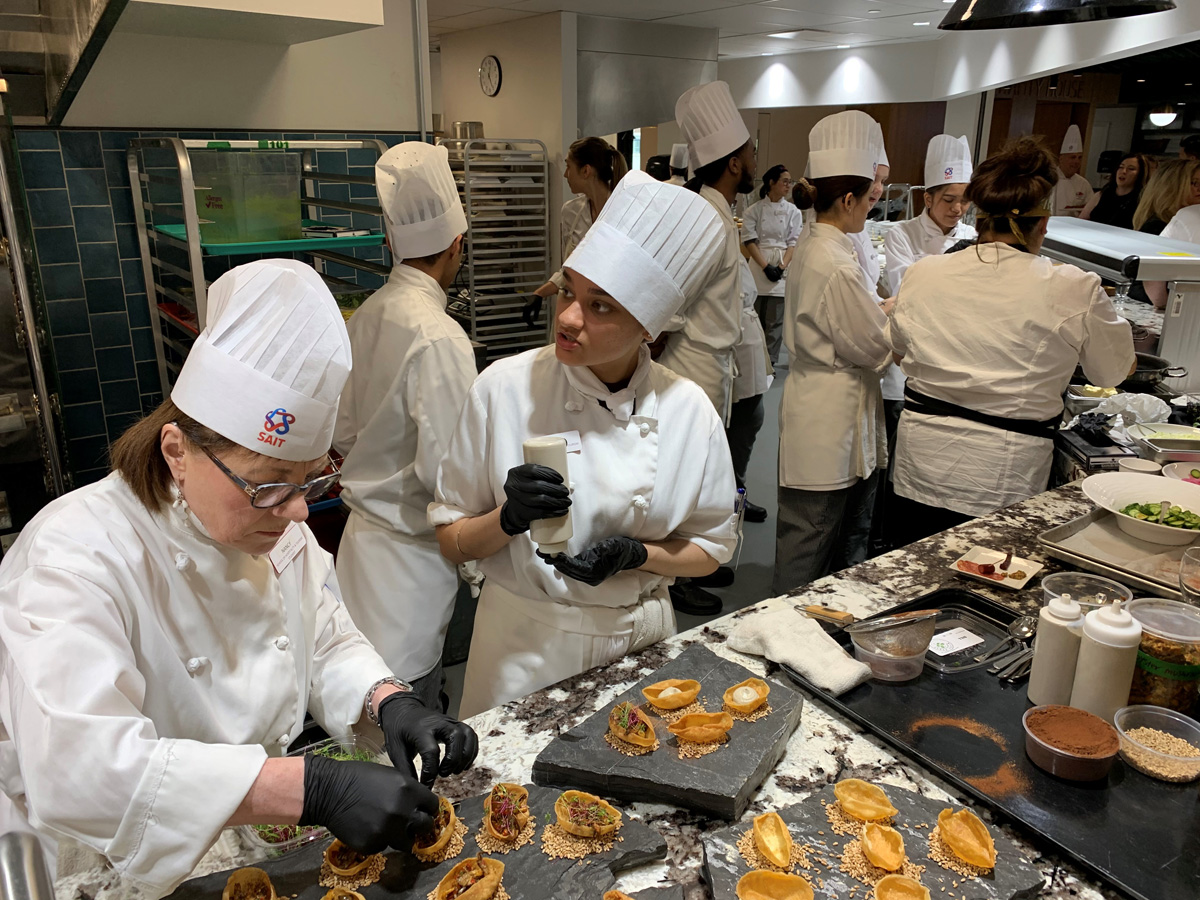 SAIT students working hard to prepare Chef Chrapchynski’s dish.