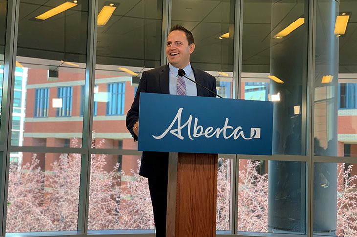 Alberta Minister of Advanced Education Demetrios Nicolaides speaks while standing at a podium